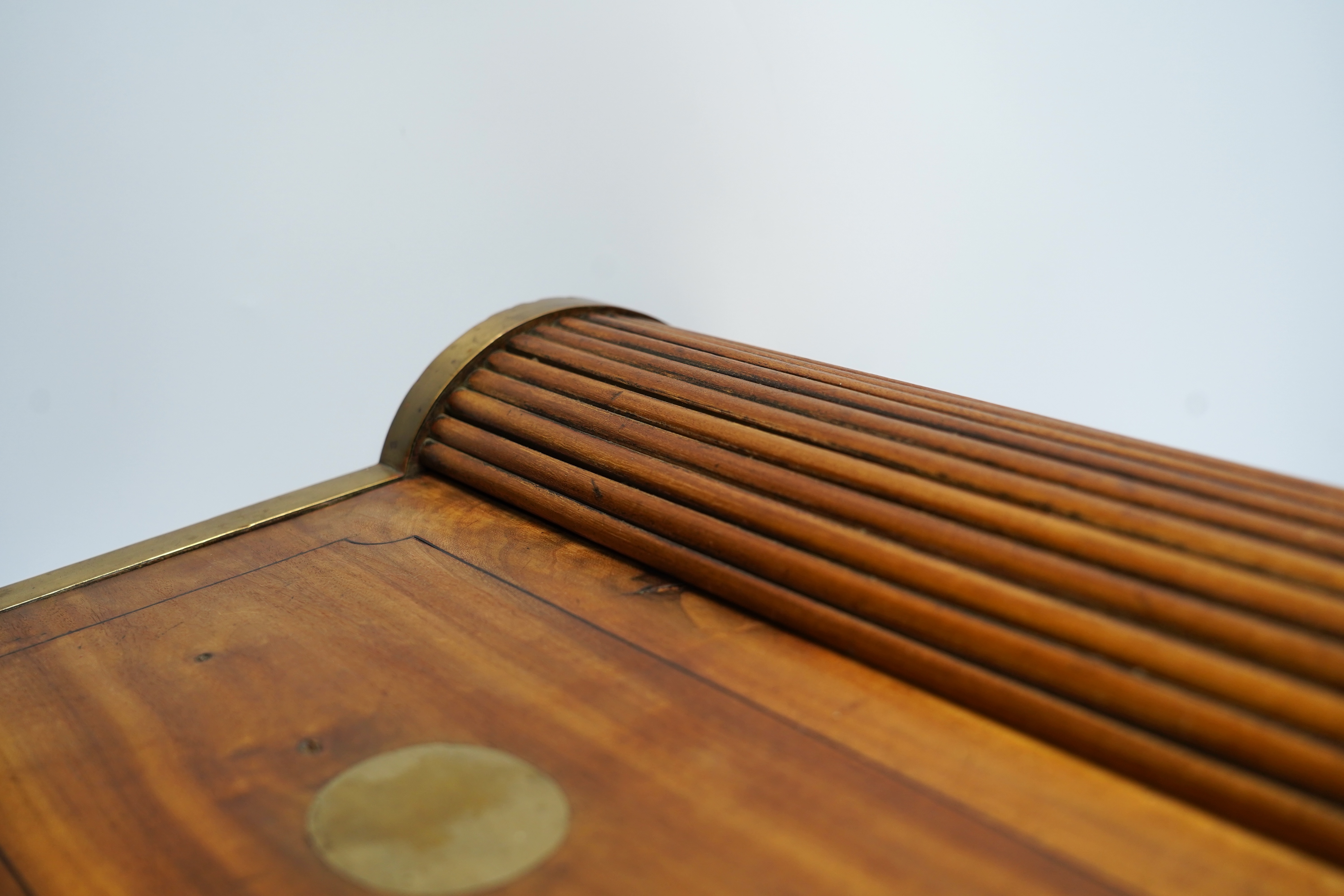 A 19th/20th century Anglo-Indian brass bound camphorwood roll top writing box, 47.5cm wide